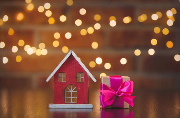 istock gift box with purple bow and  toy home 1025921894