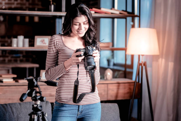 istock Happy woman looking through photos on her cam 1025934612