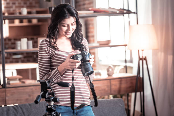 istock Content woman looking through photos on her cam 1025934744