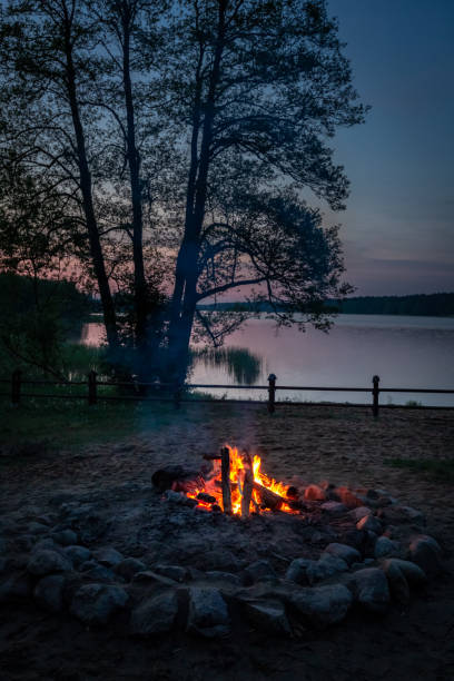 istock Warm bonfire at dusk by the lake in summer 1025937190