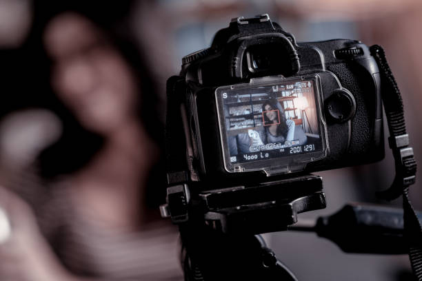 istock Inspired blogger making a video on her modern camcorder 1025937488