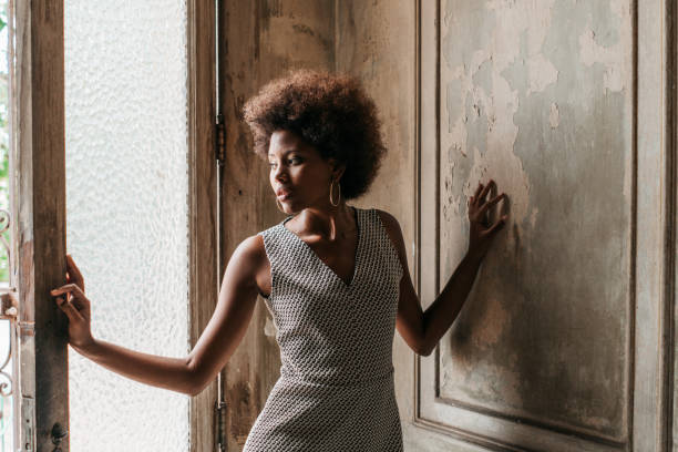 istock Thoughtful woman looking through window 1025937972