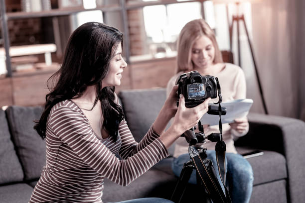 istock Happy woman fixing her camcorder 1025938162