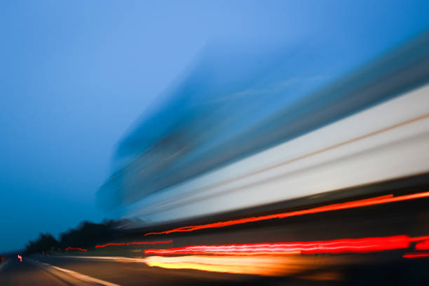 Abstract lines of traffic on highway at sunset.