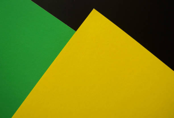 istock Dark flat lay background with color paper sheets. Black, green and yellow. 1025941940