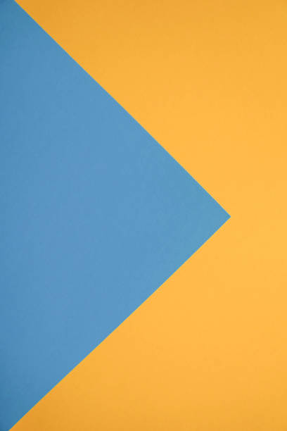 istock Unique flat lay background with color paper sheets. Yellow and blue 1025942276