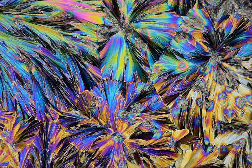 Photo through a microscope of crystals grown from the melt of sulfo-salicylic acid. Polarized light technology.