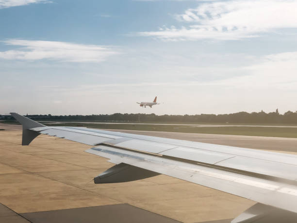 istock Airplane wing in the runway 1025954724