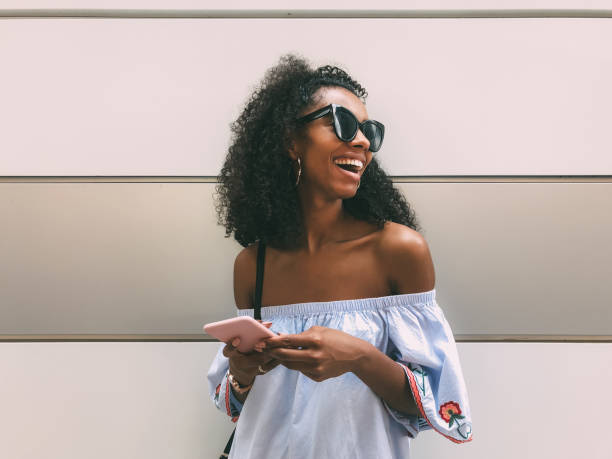 istock Cheerful black woman with mobile phone 1025954730