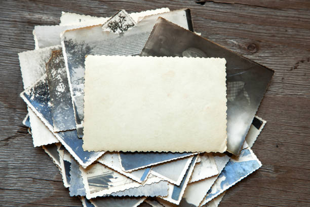 istock Stack old photos on table. Mock-up blank paper. Postcard rumpled and dirty vintage 1025958644