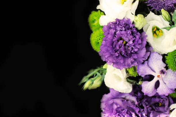 istock bouquet of green chrysanthemum, white eustoma, purple eustoma, purple orchid on a black background on the right side 1025959708