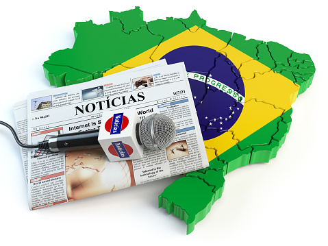 Brazilian news, press and  journalism concept. Microphone and newspaper with headline \