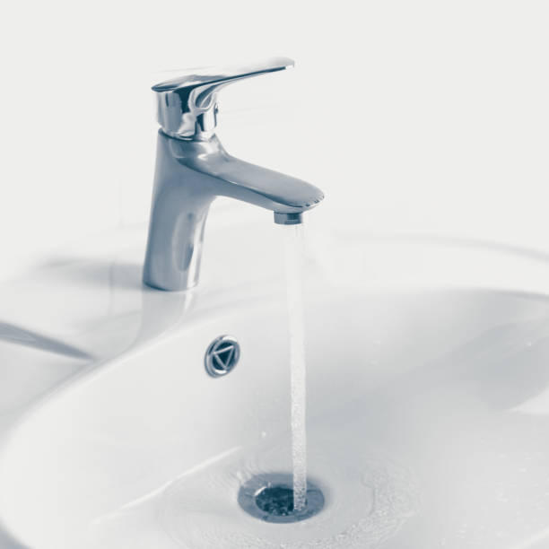 istock faucet and wash sink with flowing water 1025966726