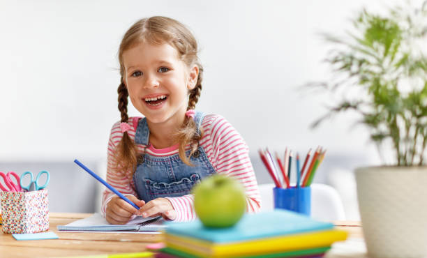 istock child  girl  doing homework writing and reading at home 1025970722