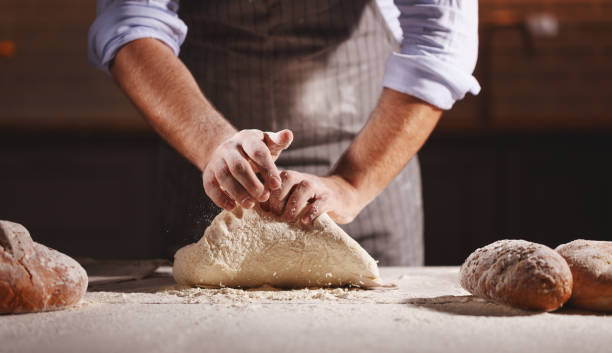 istock hands of baker's male knead dough 1025971168