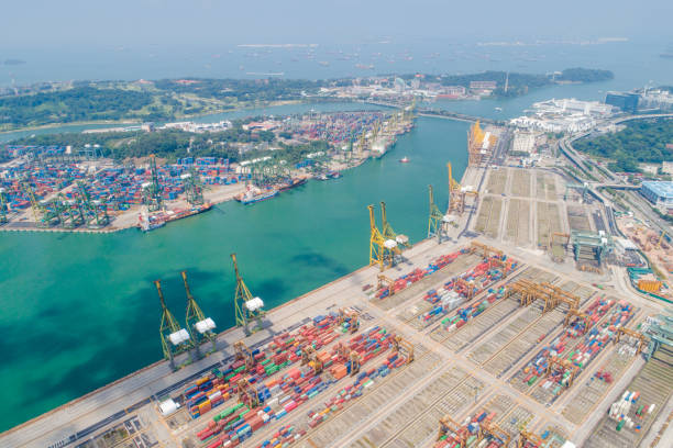 istock Container Cargo freight ship with working crane bridge in shipyard in singapore 1025971460