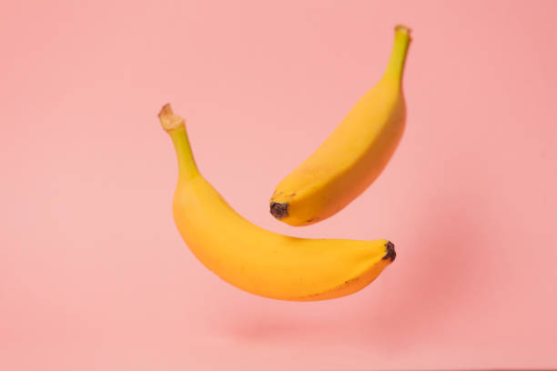 istock Two yellow bananas levitate in air 1025979436