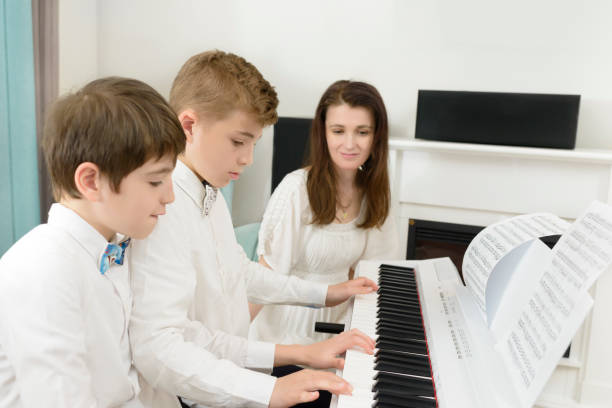 istock Kids Studying and Playing Piano in Tandem 1025983090