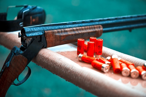 Hunting shotgun with bullets cartridges drop rain