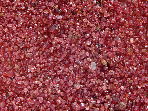close-up of pink sand of garnet crystals macrophotographie of crystals from a french river in Massif Central garnet stock pictures, royalty-free photos & images