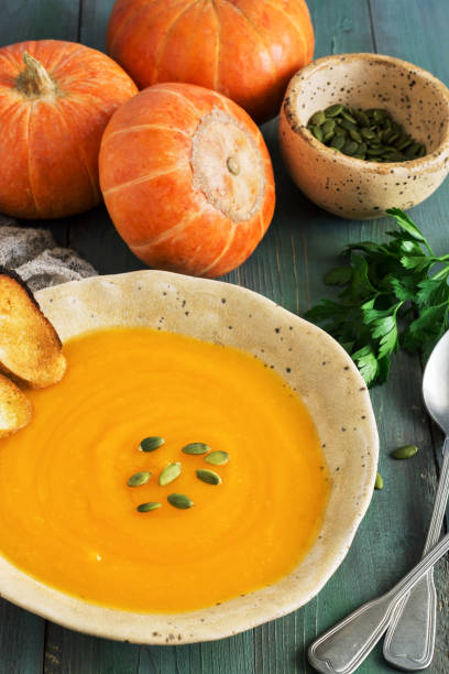 istock Pumpkin cream soup on a rustic green wooden table. selective focus. 1026008004