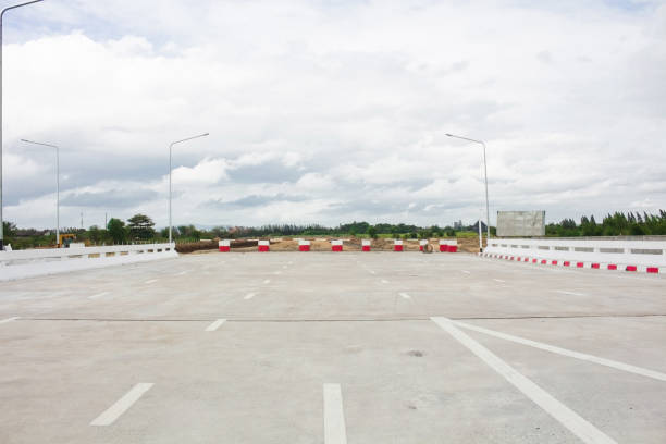 istock Worn Road Closed barricade blocks road construction site 1026022524