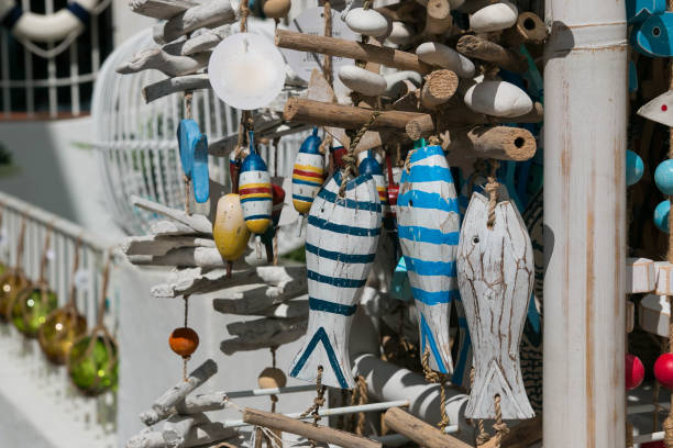 Handcraft wooden fishes on sale outside a shop. Calella de Palafrugell, Spain. stock photo