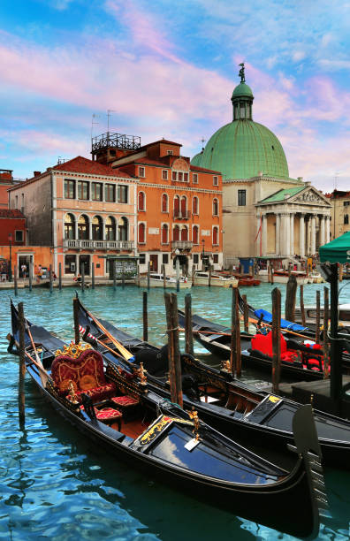 Moored Gondolas in foreground with San Simeon Piccolo church in the background in Venice, Italy stock photo