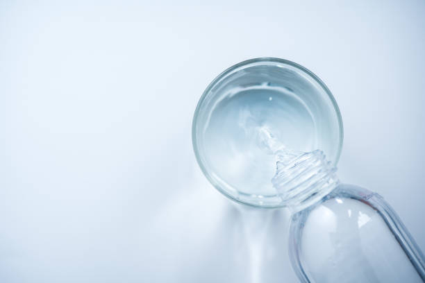 istock pouring water from bottle into glass 1026036006