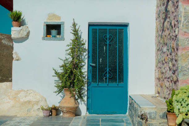 istock Old white house with blue door 1026036432