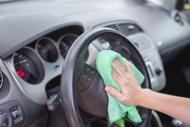istock Young woman cleaning car interior with microfiber cloth. Car detailing. 1026036728