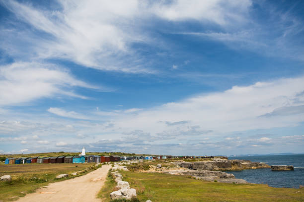 istock Old Lower Lighthouse and Coloured Fishing Cabins 1026036988