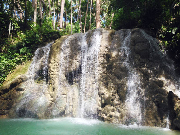 Lugnason Falls in San Juan, Siquijor Island, near Dumaguete, Negros Oriental, Philippines tropical waterfall siquijor island stock pictures, royalty-free photos & images