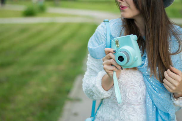 istock Girl with instant camera 1026039628