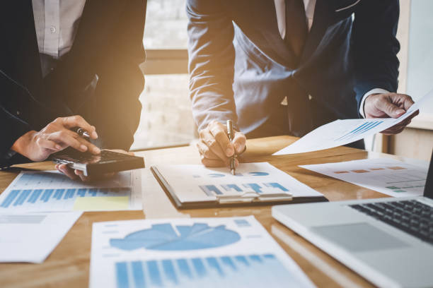 istock Executive team discussing the charts and graphs working in business strategy and financial plan to investment profit, discussing working analysis with financial data and marketing growth report 1026040294