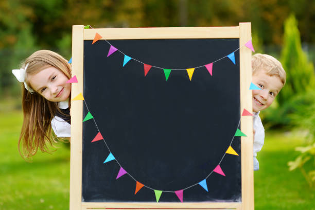 Two adorable little schoolkids feeling excited about going back to school