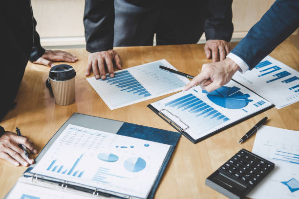 istock Executive team discussing the charts and graphs working in business strategy and financial plan to investment profit, discussing working analysis with financial data and marketing growth report 1026040532