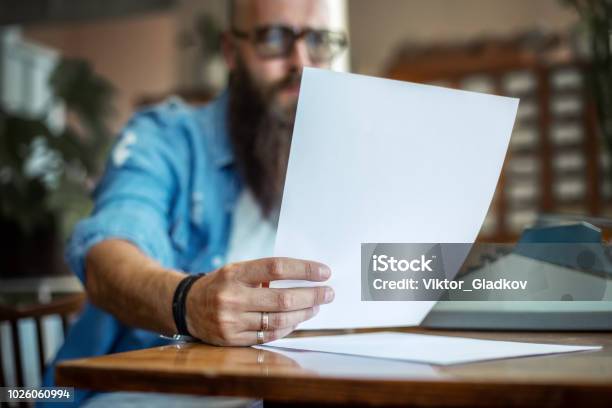 Bearded Stylish Writer Reading His Novel Stock Photo - Download Image Now - Letter - Document, Writing - Activity, Machinery