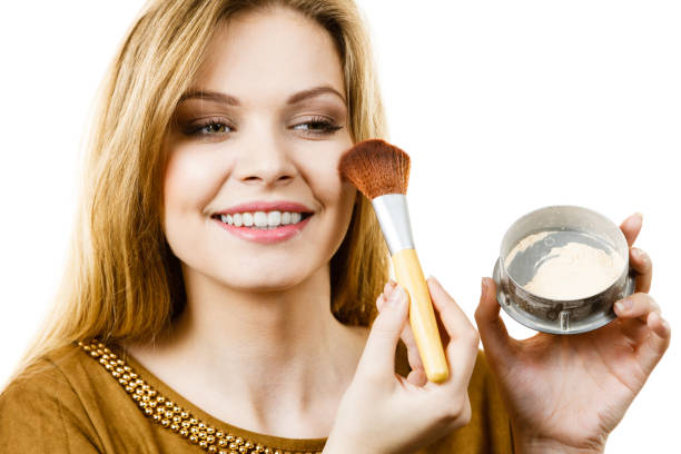 istock Smiling woman holding make up brush 1026061444