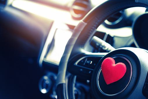 Steering wheel with heart red object.Love car concept idea.interior console car.