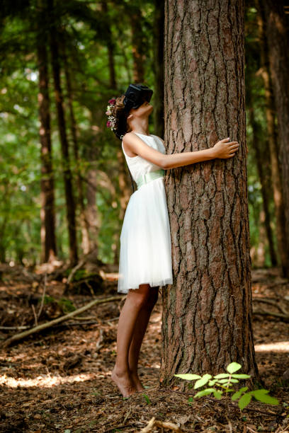 istock young girl making virtual reality experience with vr glasses in the forest 1026069642