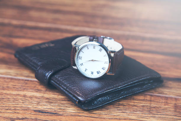 istock man elegant wallet and watch on wooden table 1026069668