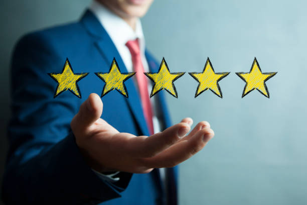 istock man hand yellow  stars in screen 1026069830