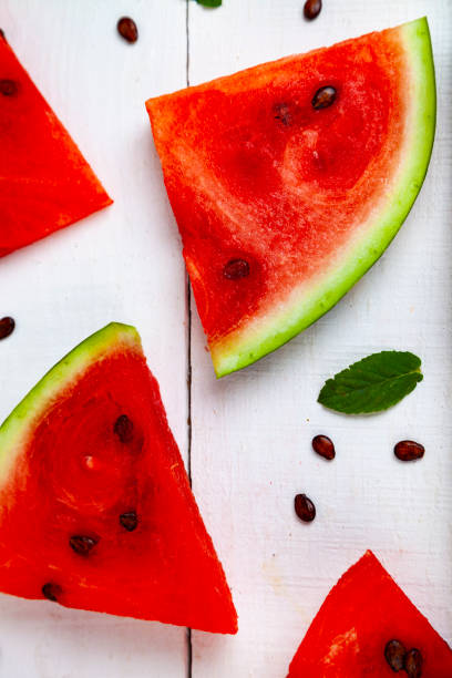 istock Pieces of watermelon on a white wooden table 1026070470
