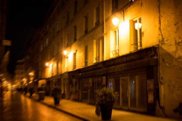 istock Blurry motion image of a street at night in Paris. 1026077850