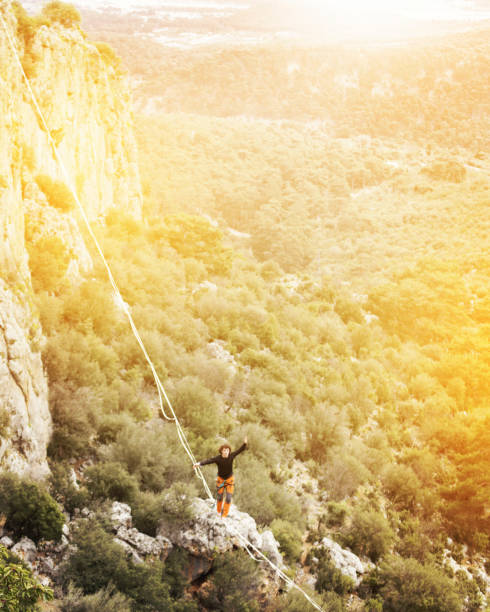 istock A man is walking on a rope over an abyss. 1026083140