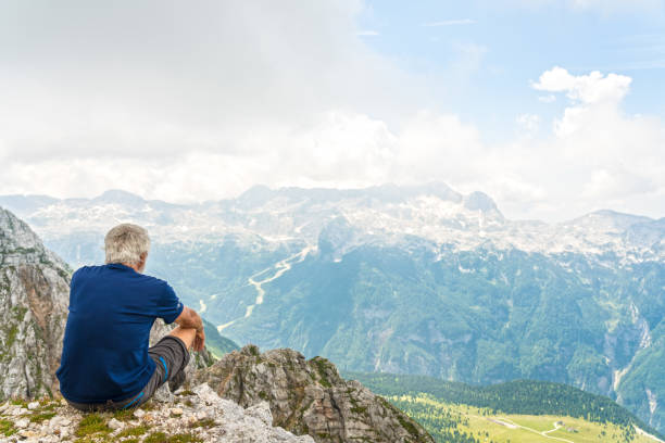 istock Senior man high up in the mountains 1026083282