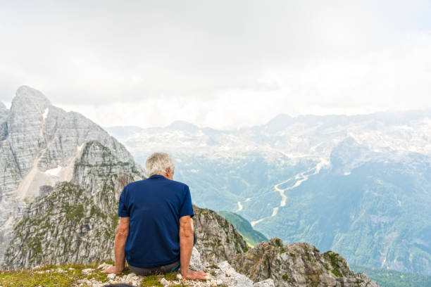 istock Senior man high up in the mountains 1026083346
