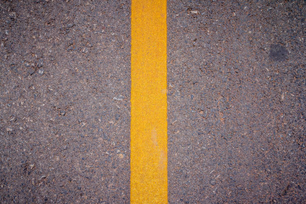 istock Asphalt road surface with yellow line 1026083372