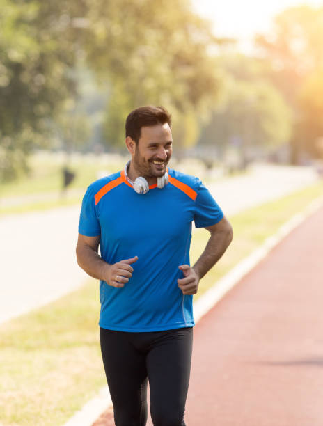 istock Attractive man running at sport track 1026090218